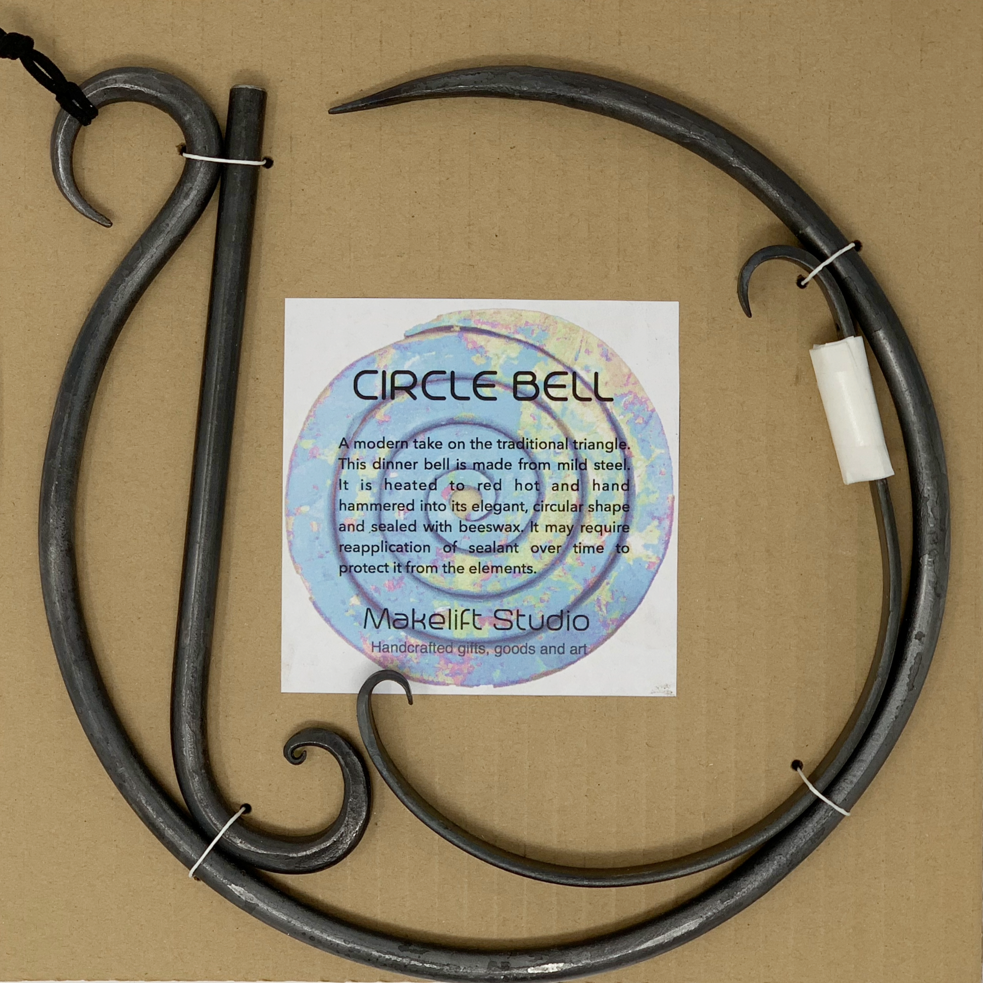 Circular shaped steel dinner bell includes  hanger and striker packaged